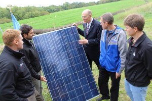 Elizabethtown College President Carl Strikwerda, center, with project partners (left) and faculty (right) examine a solar panel that will be installed as part of the largest solar array on any PA campus. Photo by Lynn Rebuck/ LititzDailyNews.com