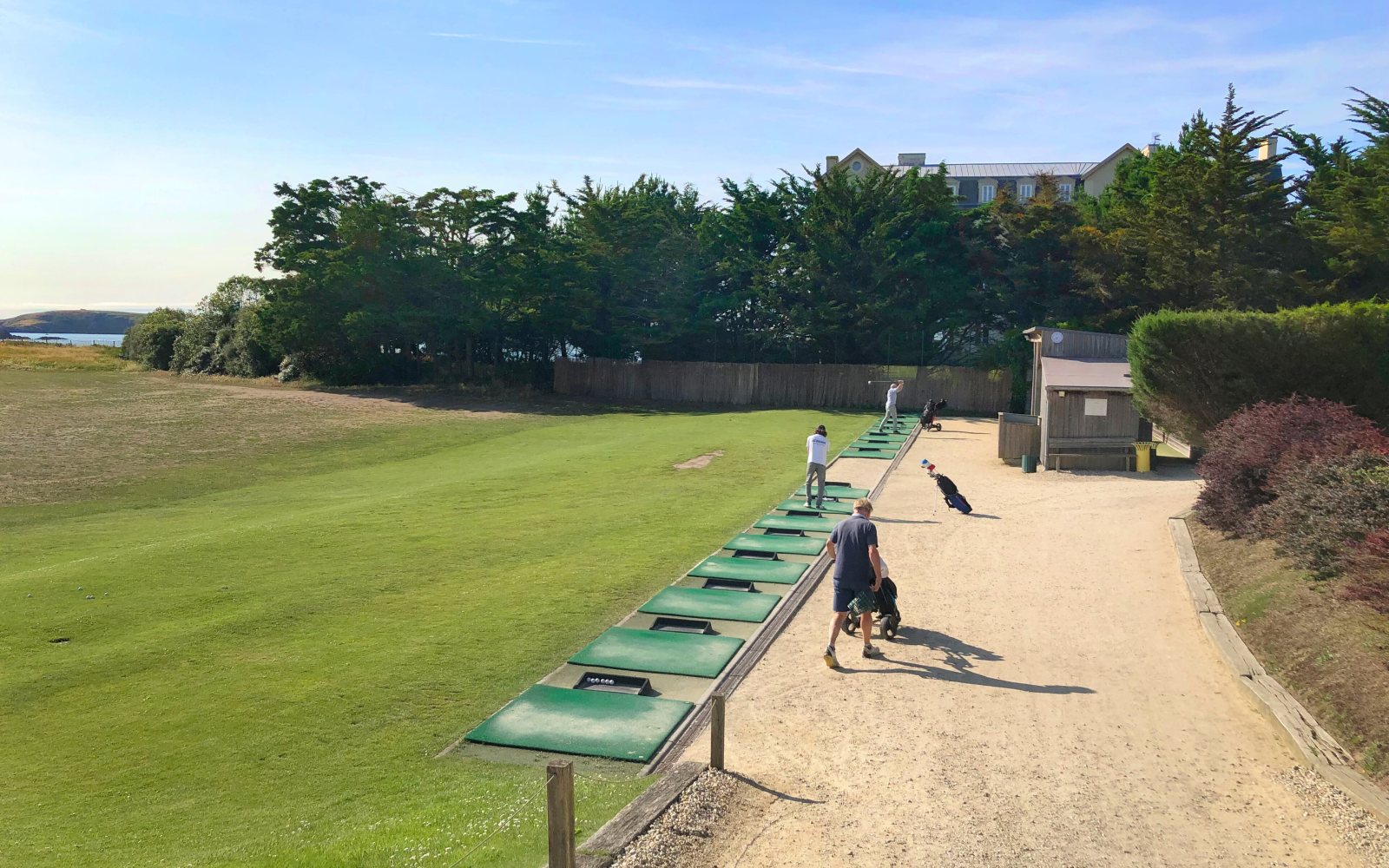 Golfer swinging on a practice range