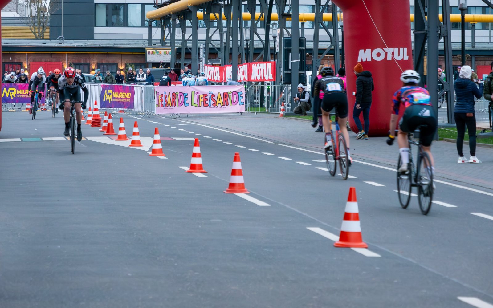Cyclists racing through a downtown street