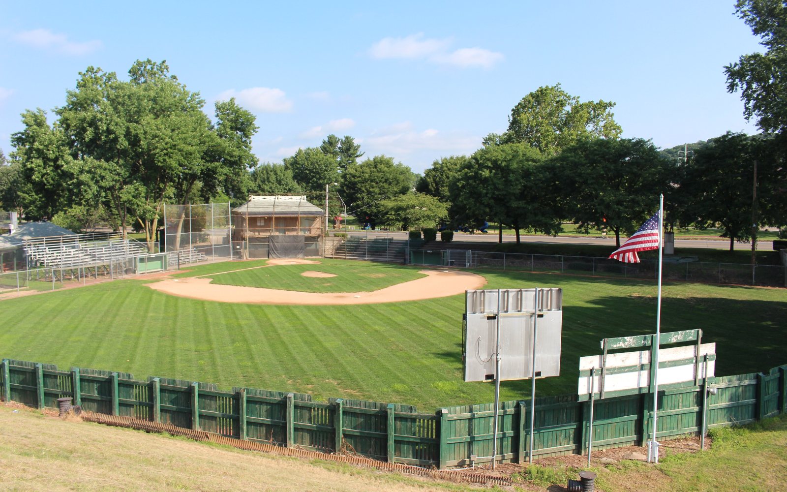 A youth baseball field with an infield and outfield fence