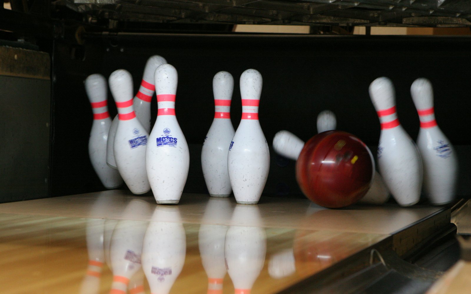 Bowling ball rolling toward pins