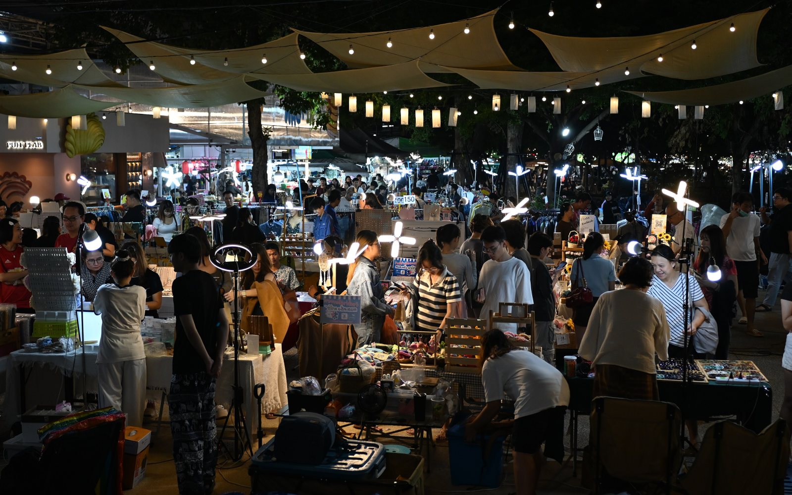 Shoppers browsing at an outdoor craft fair