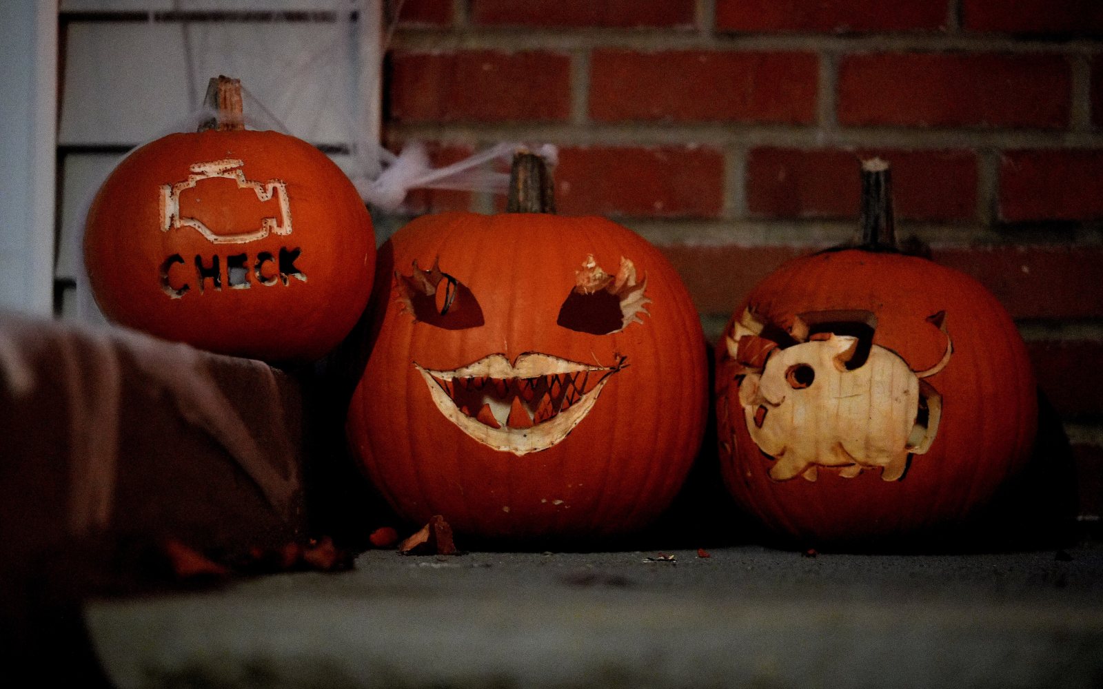 Carved jack-o'-lanterns glowing on a porch