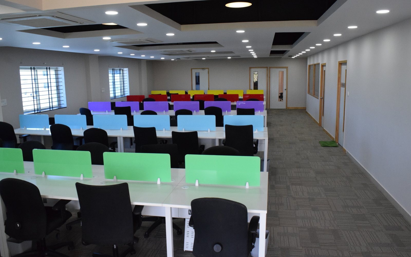 People working at shared desks in a co-working space