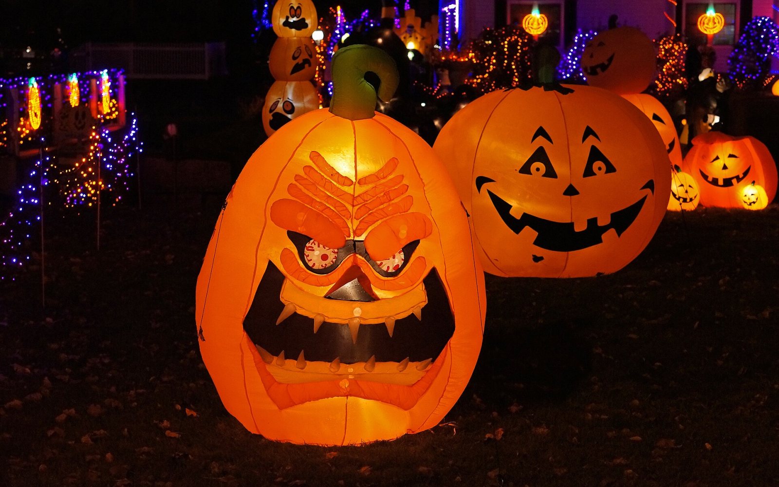 Carved jack-o'-lanterns glowing on a porch