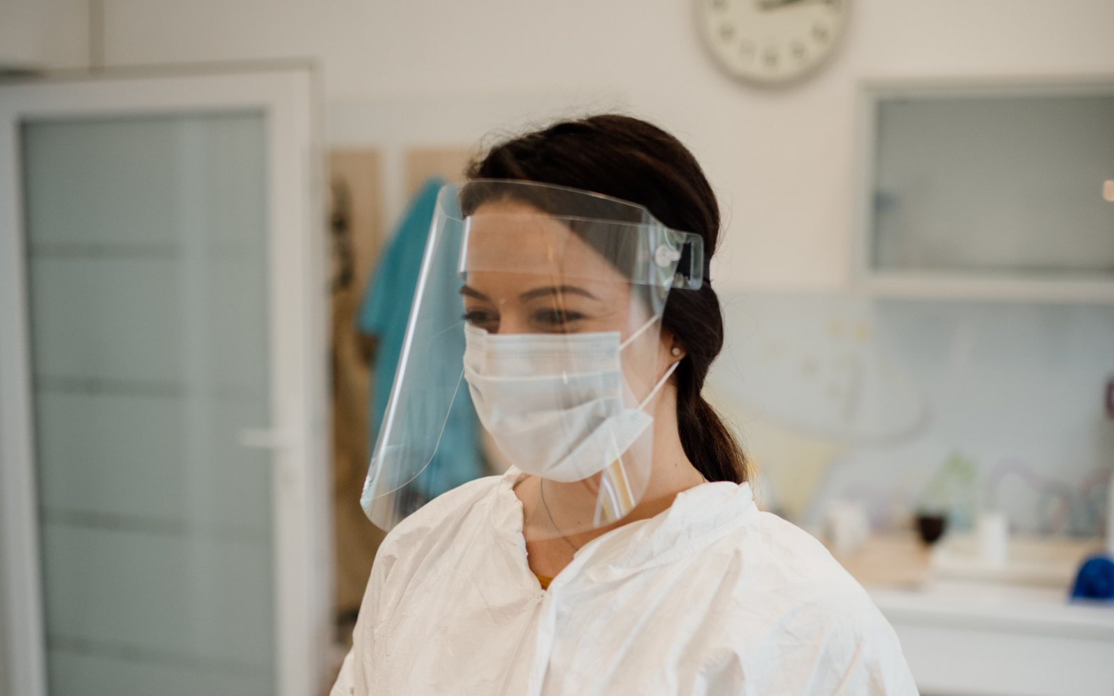 A healthcare worker wearing a protective face shield