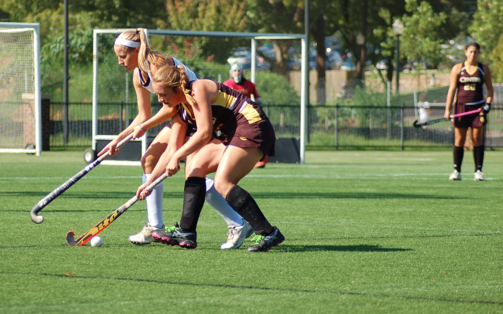 Field hockey players competing for the ball